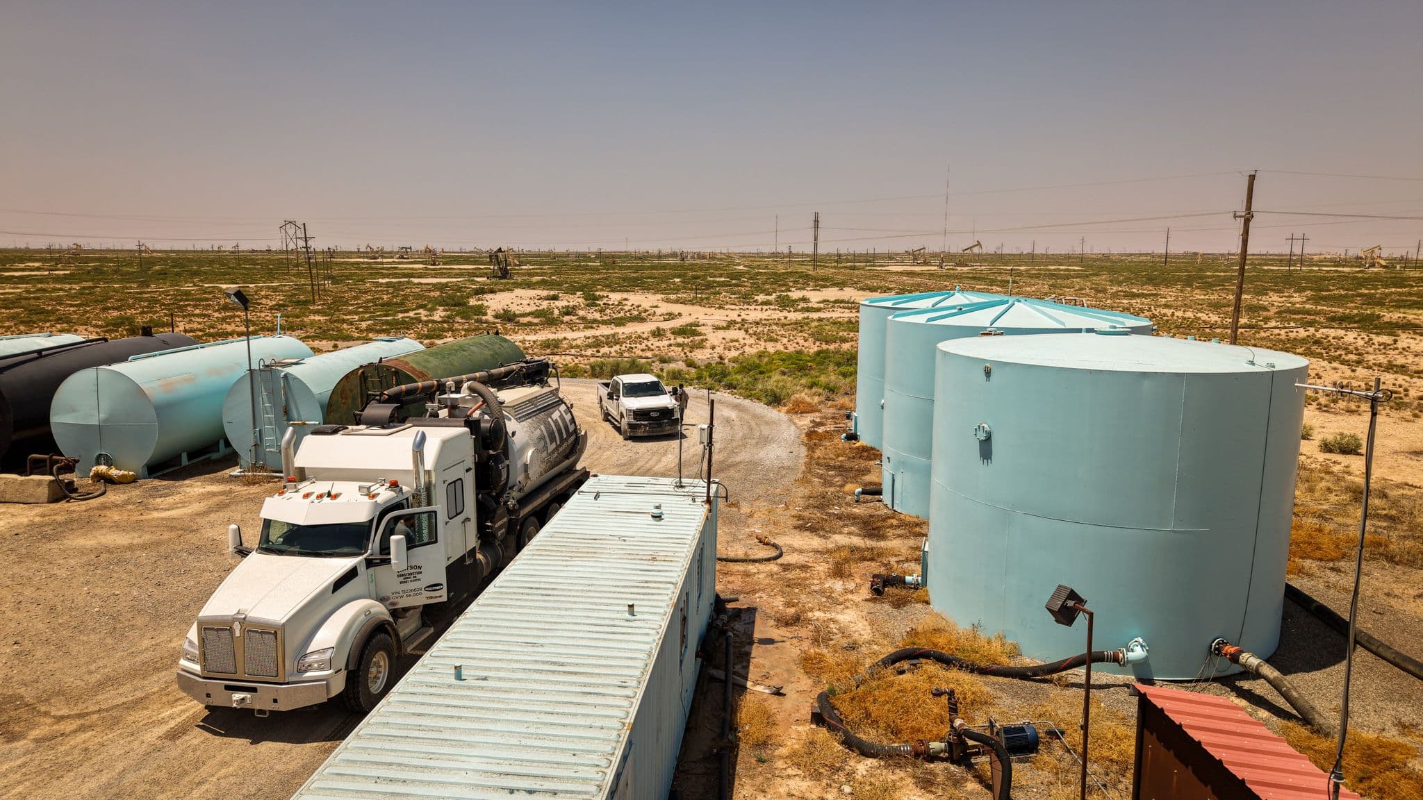 Commercial water trucks positioned at an Alfadale loading station